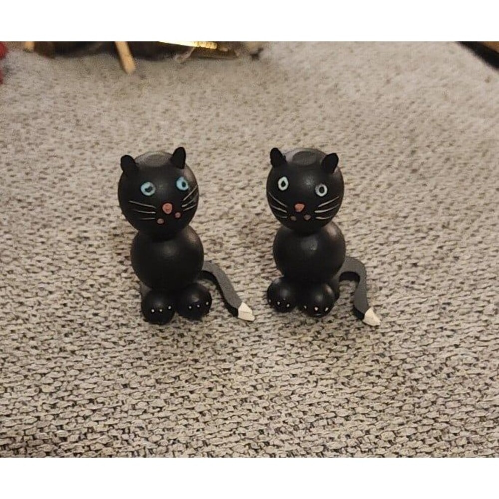 2 black wooden cats